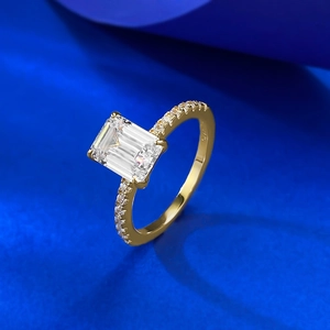 Macro detail of S925 hallmark on a gold rectangular cut emerald ring setting