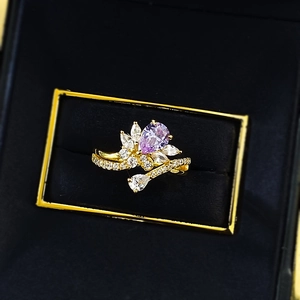 Elegant gold plated S925 silver ring with a pear-cut purple gemstone in a jewelry box