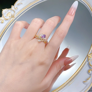 Detailed close-up of a S925 silver ring with purple pear-shaped gem and white accents