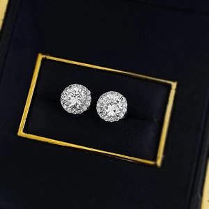 Classic round halo stud earrings with brilliant cubic zirconia in a blue jewelry box
