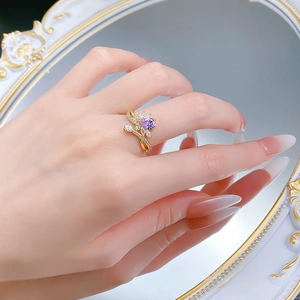 Macro detail of S925 silver ring featuring a purple pear-cut stone and leaf-shaped zircons