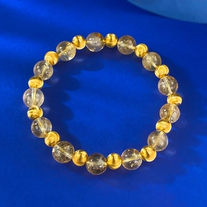 Elegante bracciale con perline di cristallo citrino giallo 8mm e dettagli oro su sfondo blu