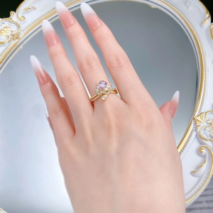 Detail of s925 silver ring featuring a pink pear-cut stone with floral accents on hand
