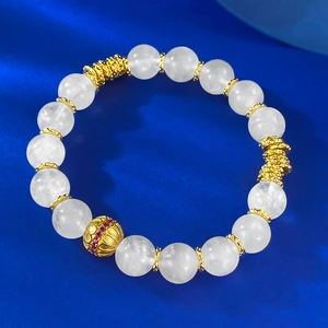 Detail of beaded moonstone bracelet with vintage gold floral spacers and red zircon accents