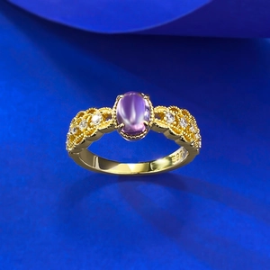 Detailed macro shot of vintage S925 silver ring with purple stone and intricate lace engraving