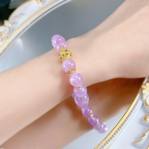 Macro view of 10mm lavender amethyst bracelet with elegant hollow golden filigree bead