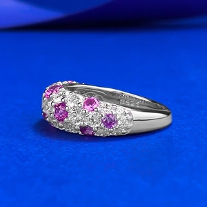 S925 silver half eternity ring with pink and white pavé cubic zirconia on blue background