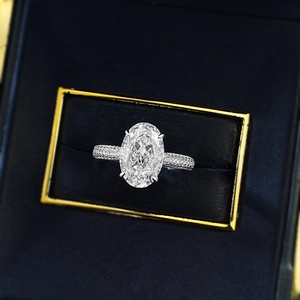 Macro shot of oval cut high carbon diamond ring with micro-pave band in velvet box