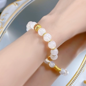 Elegant S925 silver moonstone beaded bracelet with golden shell charm on a model's wrist