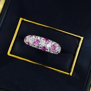 Macro shot of S925 silver ring featuring pink and clear gemstones in a velvet box