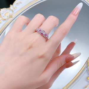 Close-up of S925 silver ring with pink and white gemstones on a woman's finger