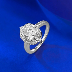 Macro view of cushion-cut halo engagement ring showing the S925 hallmark and milgrain detail