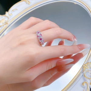 Close-up of S925 silver wave ring with pink and white pavé stones on a vintage mirror