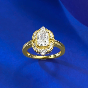 Detailed macro view of S925 hallmark on a gold halo ring with a radiant cut centerpiece