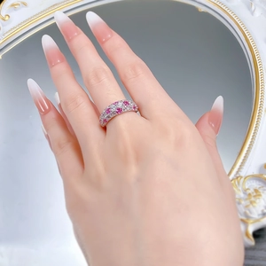 Detail of S925 silver ring featuring sparkling pink and white pavé-set gemstones on finger