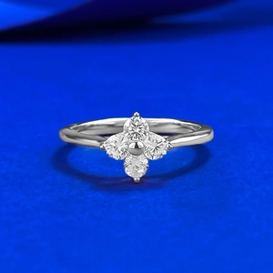 Elegant S925 silver four-leaf clover ring with sparkling round-cut crystals in blue background