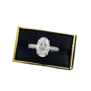 Elegant 8x12mm oval cut silver ring with pavé diamonds in a navy velvet jewelry box