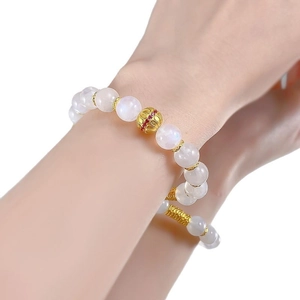 Elegant S925 silver moonstone beaded bracelet with gold hollow accents on female wrist