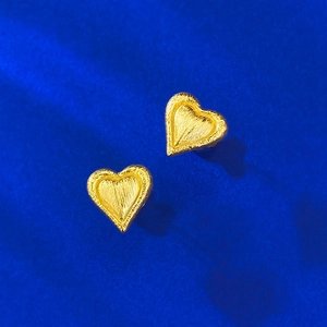 Brushed gold heart stud earrings in S925 silver on a textured deep blue background