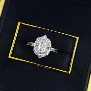 Luxury emerald-cut solitaire ring with double halo diamond setting in velvet box