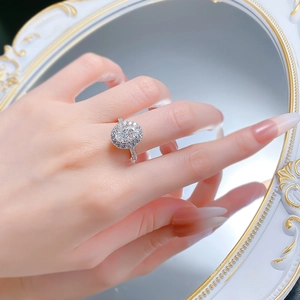 Detailed view of an oval cut diamond halo ring reflected in a vintage mirror