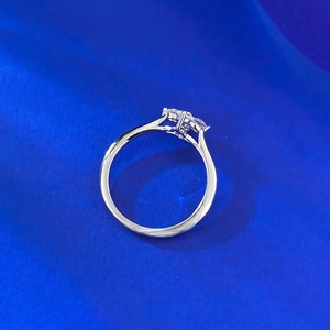 Macro shot of silver four-leaf clover ring with marquise-cut marquise moissanite stones