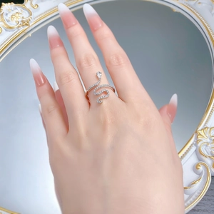 Detailed view of silver snake ring with pavé crystals and teardrop gemstone on finger