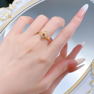 Detailed close-up of a S925 silver flower ring with red stone on a vintage mirror