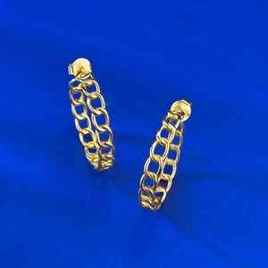 Close-up of S925 sterling silver stamp on golden chain link hoop earrings details