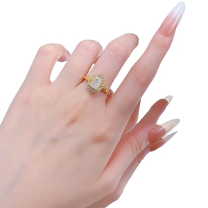 Elegant gold vintage ring with rectangular emerald cut diamond on a model's hand