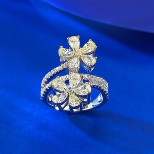 Macro shot of 925 silver flower ring with pear-cut yellow and white carbon diamonds