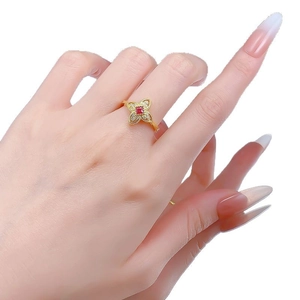 Elegant S925 silver four-leaf flower ring with red gemstone and bead edge on finger