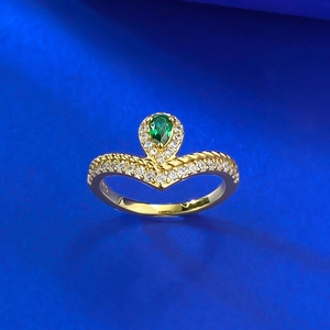 Macro shot of S925 silver stamp inside a V-shaped pear emerald gold ring band