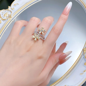 Close-up of 925 silver flower ring featuring yellow pear-cut stones and double pave bands