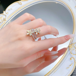 Macro detail of silver floral ring with yellow teardrop stones on a vintage mirror
