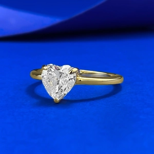 Elegant 7mm heart-cut white zircon S925 silver ring on a textured blue background
