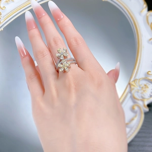 Detailed view of 925 silver flower ring with pear-cut yellow and white stones