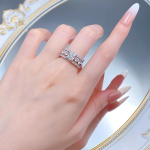 Detailed view of S925 silver wide band ring with princess cut stones on a model's hand