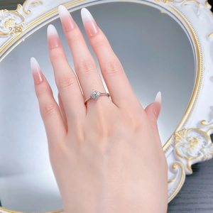 Macro detail of S925 silver clover ring with sparkling zircon stones on a model hand