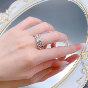Close-up of S925 silver triple row ring featuring three round main stones and pavé diamonds