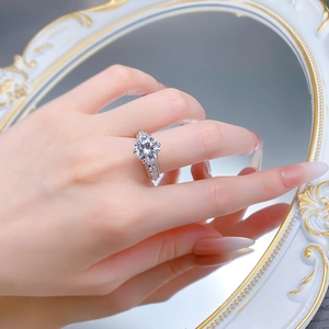 Macro shot of 10mm round sparkling diamond ring with micro-pave band in a mirror reflection