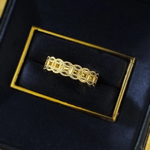 Vintage gold coin pattern ring in S925 silver with detailed texture on a blue velvet box