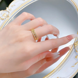 Macro view of vintage gold hollow coin pattern ring with detailed Chinese style motifs