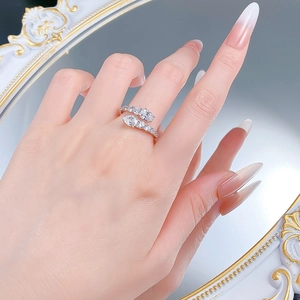 Close-up of S925 silver snake bypass ring with pear-cut zircon on female hand