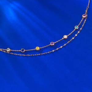 Elegant rose gold double-layered bracelet featuring colorful round cut gemstones on blue