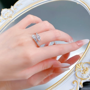 Detailed view of silver snake-shaped wrap ring with sparkling crystals on hand