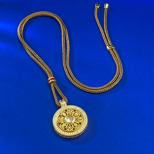 S925 silver gold-plated Eight Auspicious Symbols necklace with crystal on blue background