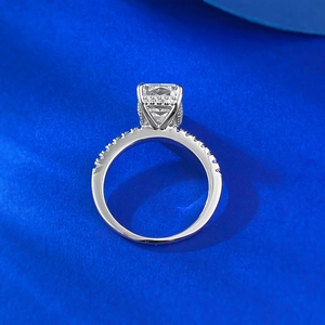Macro view of princess cut carbon diamond ring with halo setting and pavé side stones