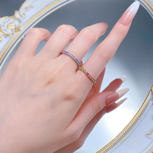 Macro view of two S925 silver rings with gradient lavender stones on a vintage mirror