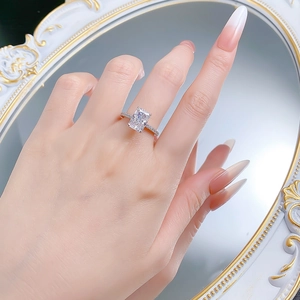 Macro detail of silver ring with radiant cut carbon diamond on a white background